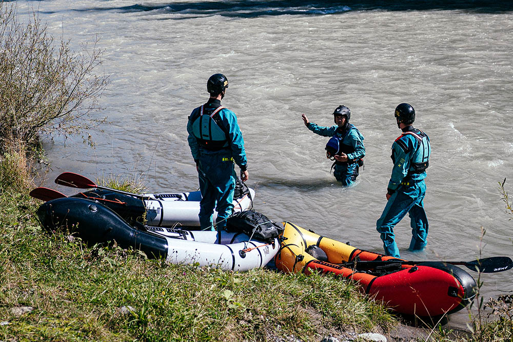 Participants receiving basic packrafting training on the Lech River in Austria, surrounded by stunning alpine scenery.